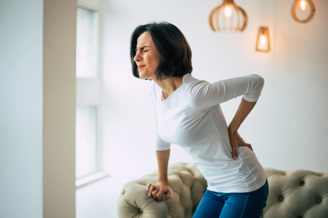 Adult woman suffering from chronic low backache.