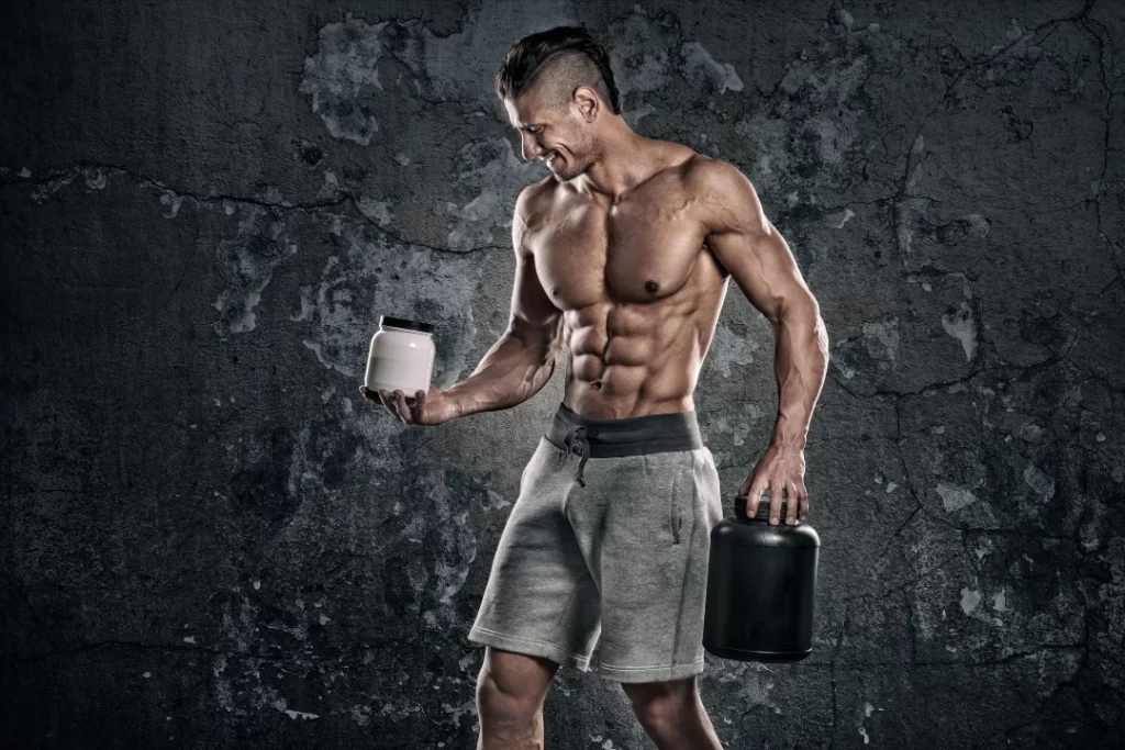 Fitness model holding whey protein that contains creatine.