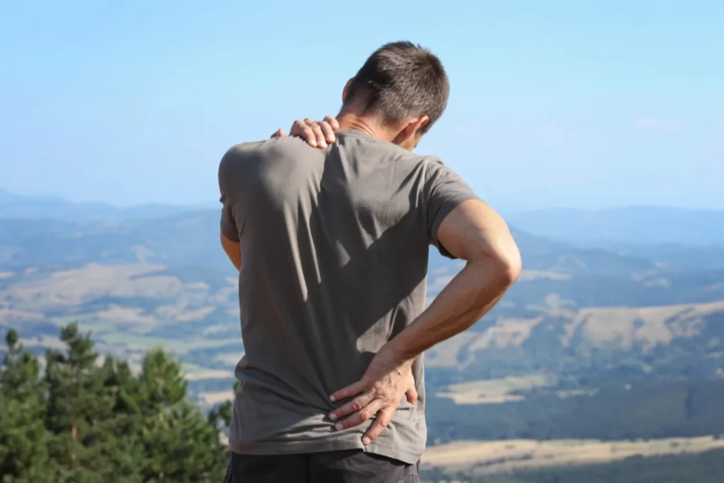 man suffering from back and shoulder pain. 