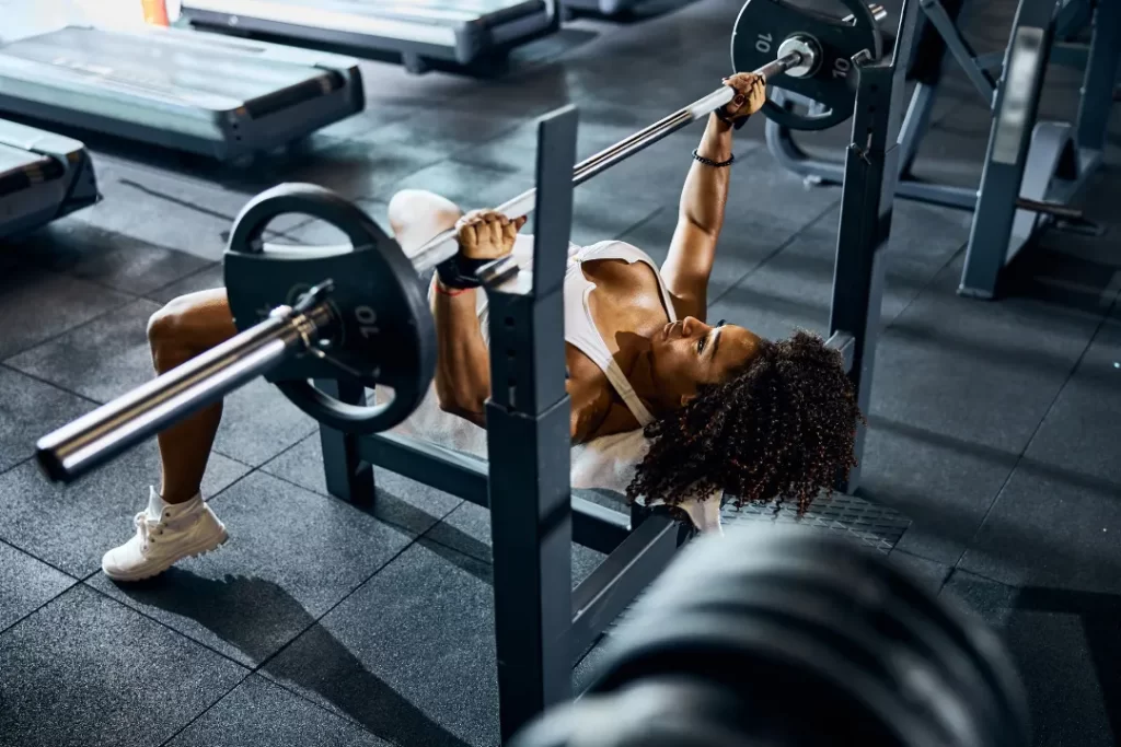 Fit girl weight lifting at the gym.