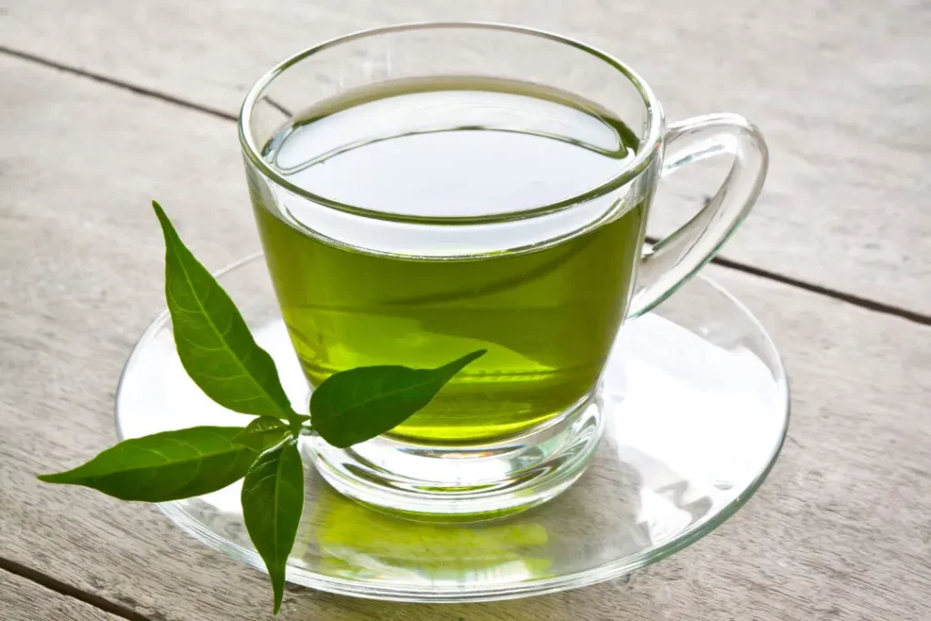 a cup of green tea on a wooden table