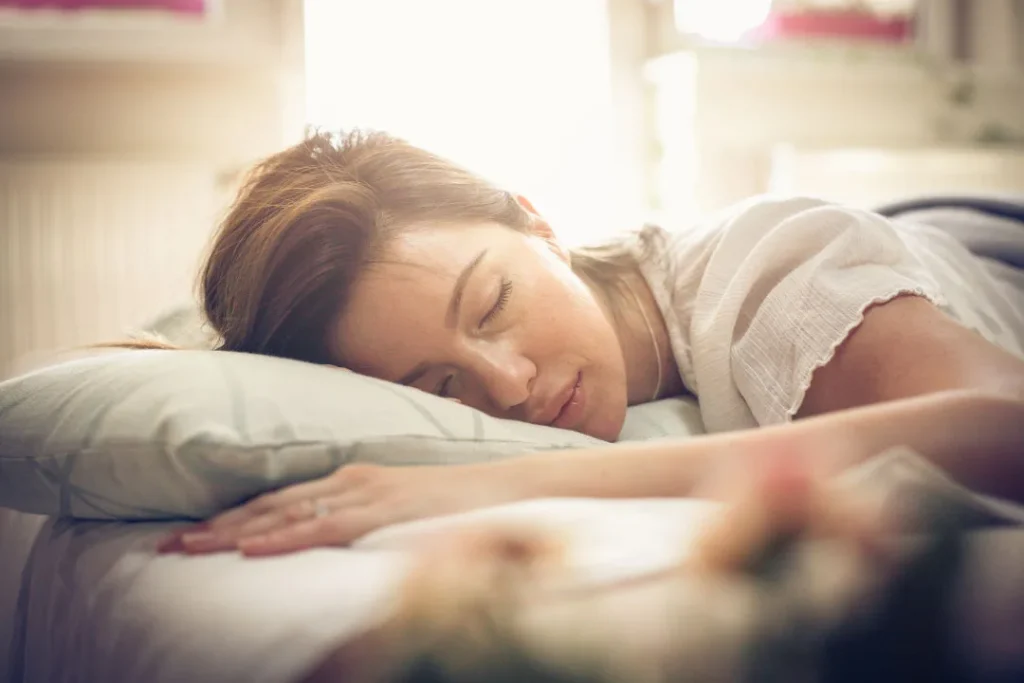 A lady sleeping on bed. 