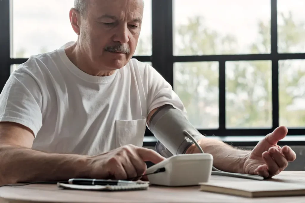 An old man examining his blood pressure. 