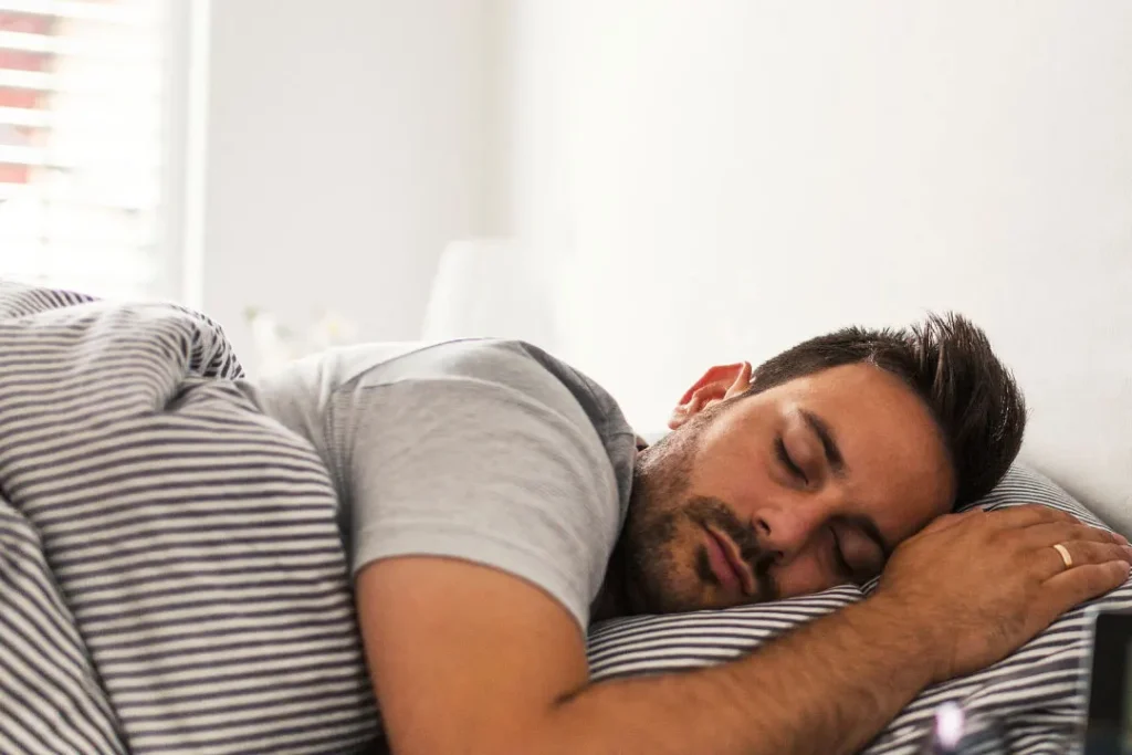 A man sleeping on bed. 