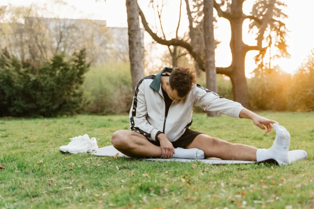 A man is doing exercise in a park. 