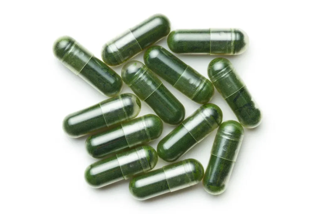 Chlorella pill on white table