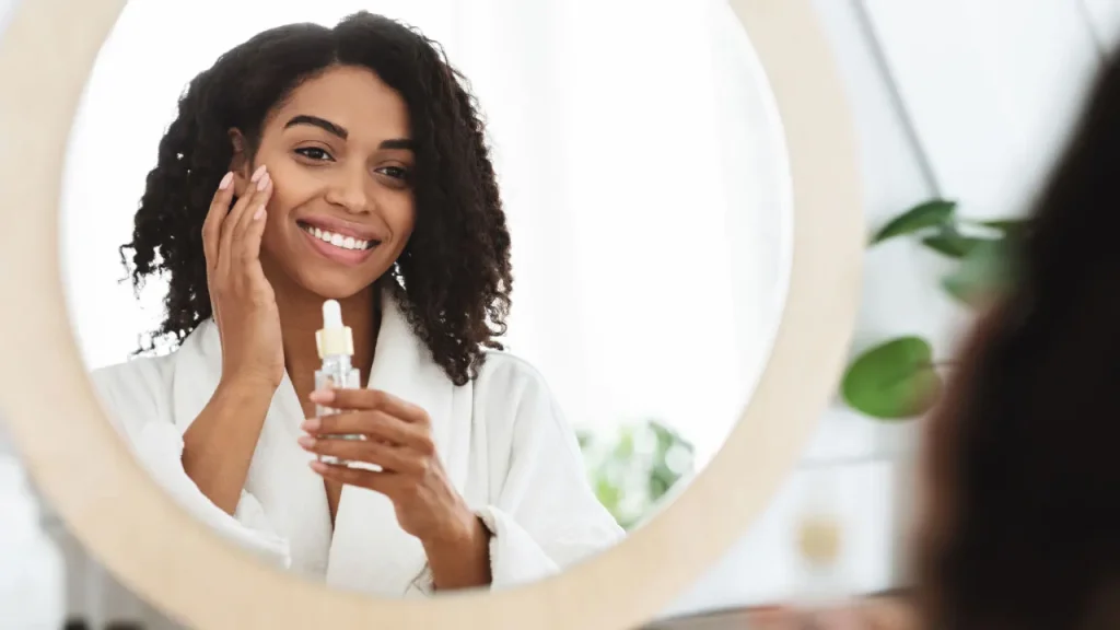 Lady using skin moisturizer. 